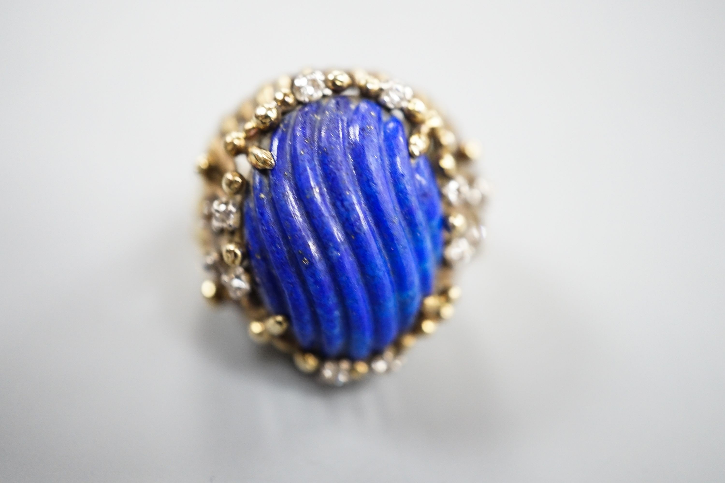 A pierced fluted 14k yellow metal, lapis lazuli and diamond set modernist dress ring, size K/L, gross weight 15.3 grams.